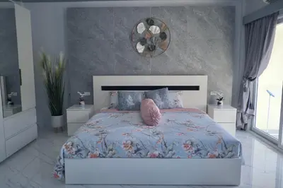 a bedroom with a bed with a pink pillow on it at GORGEOUS NEW DESIGNED 4br KataBeach sweetHome in Kata Beach