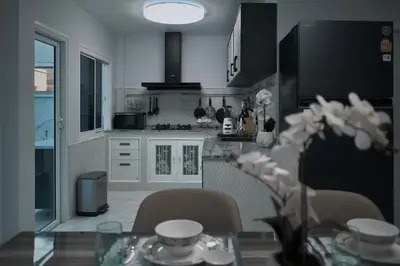 a kitchen with a glass table with chairs and a tableablish at GORGEOUS NEW DESIGNED 4br KataBeach sweetHome in Kata Beach