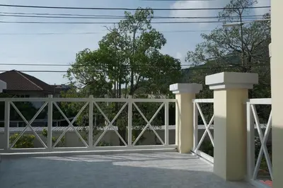 a white fence with pillars on a patio at GORGEOUS NEW DESIGNED 4br KataBeach sweetHome in Kata Beach