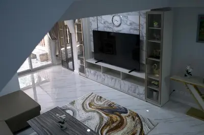 a living room with a television on a wall at GORGEOUS NEW DESIGNED 4br KataBeach sweetHome in Kata Beach