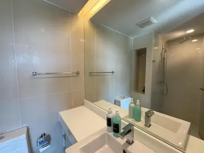 a bathroom with a sink and a mirror at Top floor apartment at Aristo by Lofty in Surin Beach