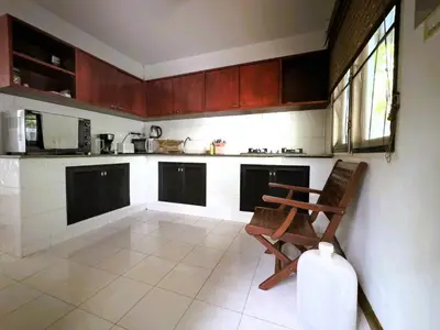 a kitchen with a chair in the middle of it at Mountain View Villa Kamala in Kamala Beach