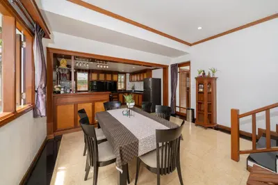 a kitchen and dining room with a table and chairs at Villa Aurora 4-bedroom Pool Villa in Kamala, Phuket in Kamala Beach