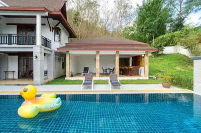 a swimming pool with a inflatable toy in front of a house at Villa Aurora 4-bedroom Pool Villa in Kamala, Phuket in Kamala Beach