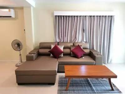 a living room with a couch and a coffee table at Kata beach townhouse in Kata Beach