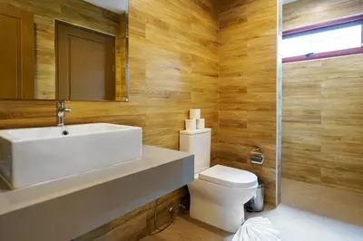 a bathroom with a sink and a toilet and a mirror at Blue Moon by G Estate Phuket in Ban Saiyuan (1)