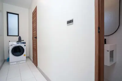 a laundry room with a washing machine and a mirror at LUXURY 4BR Oxygen Pool Villa Near Nai Harn Beach - Sunset Garden 7 in Rawai Beach