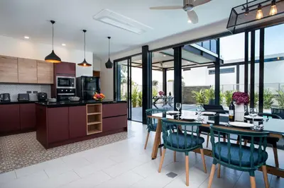 an open kitchen and dining room with a table and chairs at LUXURY 4BR Oxygen Pool Villa Near Nai Harn Beach - Sunset Garden 7 in Rawai Beach