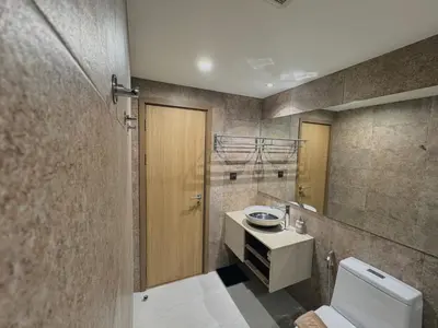 a bathroom with a toilet and a sink and a mirror at The Title VH Rawai by Beringela in Phuket Town