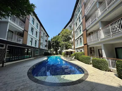 a swimming pool in a courtyard of a building at The Title VH Rawai by Beringela in Phuket Town