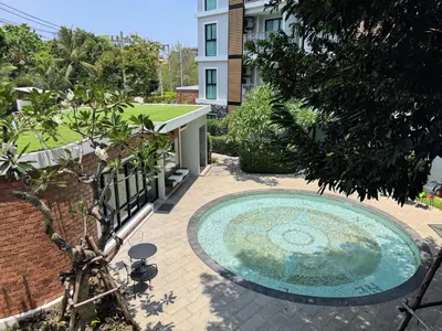 a swimming pool in a yard with a building at The Title VH Rawai by Beringela in Phuket Town
