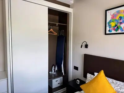 a bedroom with a bed with a yellow pillow at The Title VH Rawai by Beringela in Phuket Town