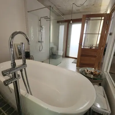 a bathroom with a tub and a glass shower at The Hip House Villa Phuket in Ban Bang Khu