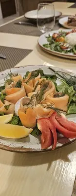 a plate of food sitting on a table at The Hip House Villa Phuket in Ban Bang Khu