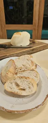 a white plate with some bread on a table at The Hip House Villa Phuket in Ban Bang Khu
