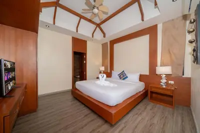 a bedroom with a large white bed and a television at VIP Pool Villa 3E1 230m Rawai Beach in Rawai Beach