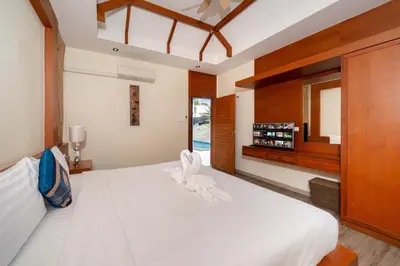 a bedroom with a large white bed with a window at VIP Pool Villa 3E1 230m Rawai Beach in Rawai Beach