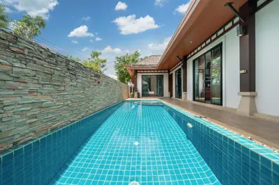 a swimming pool in a house with a brick wall at VIP Pool Villa 3E1 230m Rawai Beach in Rawai Beach