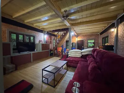 a living room with a couch and a tv at Jungle house at Yanui beach in Rawai in Phuket Town