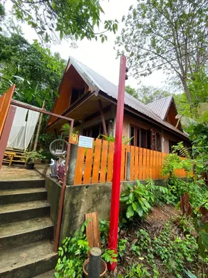 a house with a red pole in front of it at Jungle house at Yanui beach in Rawai in Phuket Town