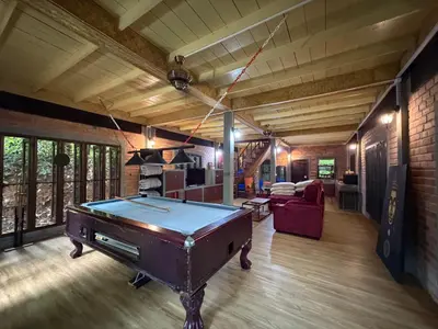 a room with a pool table in a house at Jungle house at Yanui beach in Rawai in Phuket Town