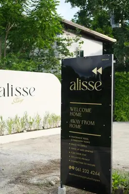a sign in front of a building at Alisse Stay Phuket Layan in Phuket Town