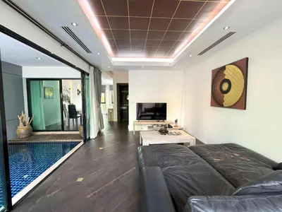 a living room with a couch and a pool at Kamala townhome with sea view terrace & pool in Kamala Beach