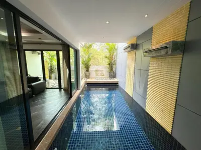 a swimming pool in the middle of a house at Kamala townhome with sea view terrace & pool in Kamala Beach