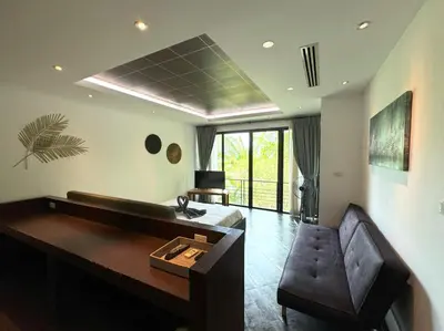 a living room with a bed and a couch and a desk at Kamala townhome with sea view terrace & pool in Kamala Beach
