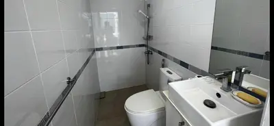 a bathroom with a white toilet and a sink at Patong tower 2bedroom 2 bathrooms, corner view in Patong Beach