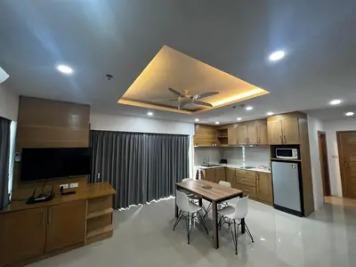 a kitchen with a table and a ceiling fan at Patong tower 2bedroom 2 bathrooms, corner view in Patong Beach