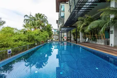 a swimming pool in a building with trees at C260 Beach And Town, Modern Big Apartment in Phuket Town