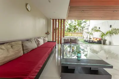 a living room with a red couch and a glass table at C260 Beach And Town, Modern Big Apartment in Phuket Town