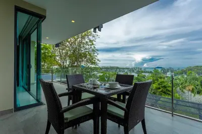 a table and chairs on a balcony with a view at C260 Beach And Town, Modern Big Apartment in Phuket Town