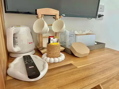a kitchen counter with a coffee maker and a remote control at La Depa PP House in Phi Phi Don