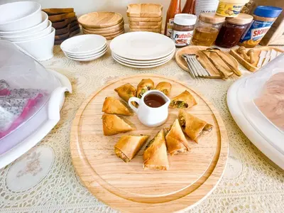 a table with a plate of bread and a cup of coffee at La Depa PP House in Phi Phi Don