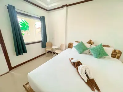 a bedroom with a bed with a towel on it at La Depa PP House in Phi Phi Don