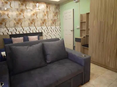 a living room with a couch in a room at Fora Boutique Hotel in Karon Beach