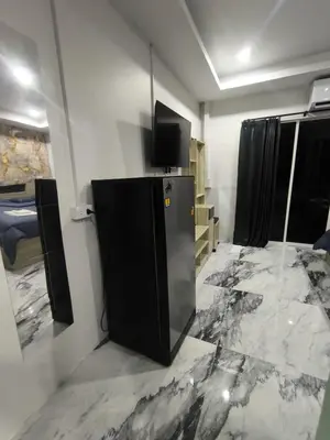 a kitchen with a black refrigerator in a room at Fora Boutique Hotel in Karon Beach
