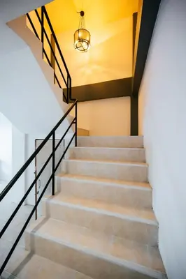 a staircase in a house with a light fixture at Fora Boutique Hotel in Karon Beach