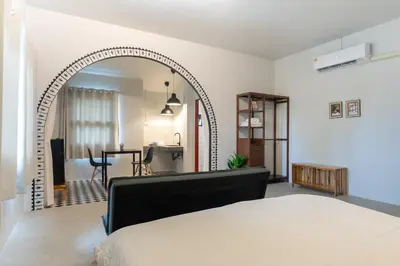 an archway in a bedroom with a living room at Baan Old Town Boutique Stay, Phuket Town in Phuket Town
