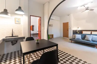 a living room with a table and a couch at Baan Old Town Boutique Stay, Phuket Town in Phuket Town