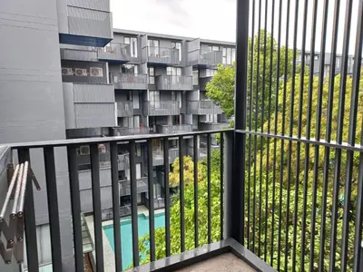 an apartment balcony with a view of a building at The Deck Condo Patong 5Fl Pool View in Patong Beach