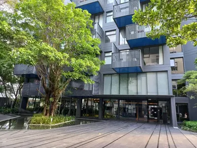 a building with a wooden walkway in front of it at The Deck Condo Patong 5Fl Pool View in Patong Beach