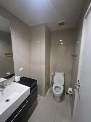 a bathroom with a white toilet and a sink at The Deck Condo Patong 5Fl Pool View in Patong Beach