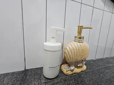 a white container sitting on the floor next to a wall at Haru Inn Airport in Ban Bo Han
