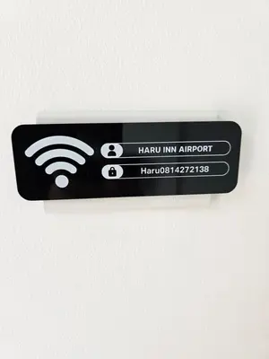a black sign with a wifi symbol on it at Haru Inn Airport in Ban Bo Han