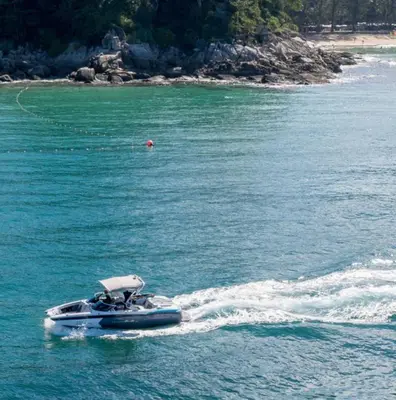 a speed boat on a body of water at Ozone Phuket Kata Beach Resort & Wellness in Kata Beach