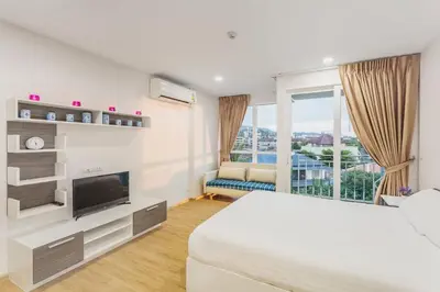 a hotel room with a bed and a large window at Ozone Phuket Kata Beach Resort & Wellness in Kata Beach