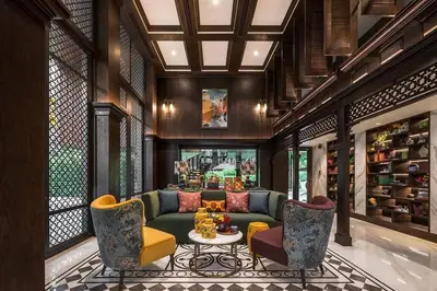 a living room with a green couch and chairs at PRIME TOWN Phuket Resort & Wellness in Ban Rangeng